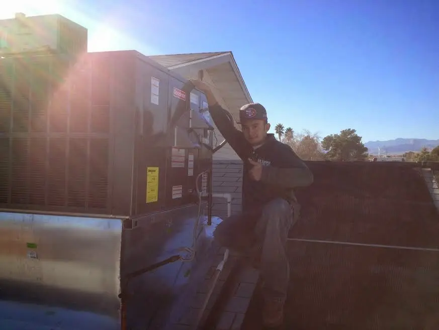 HVAC technician performing Boiler Repair on a rooftop unit in Willows